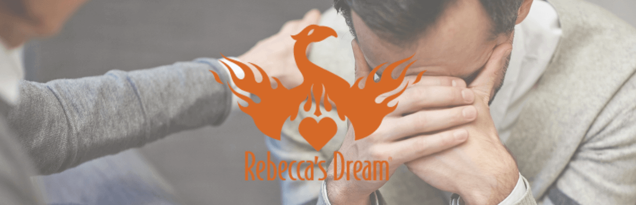 Rebecca's Dream phoenix logo overlaid on image of person being comforted, highlighting support and mental health advocacy.